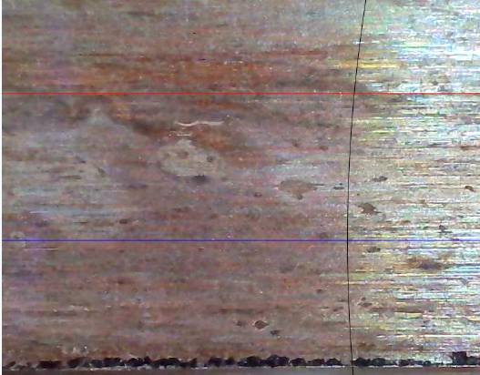 Close-up showing pitting and corrosion along a skate blade.